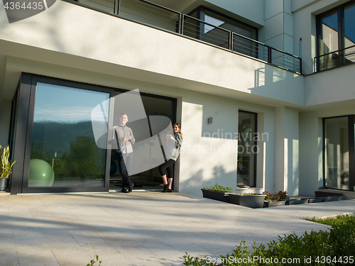 Image of couple enjoying on the door of their luxury home villa