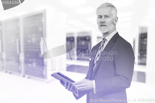 Image of Senior businessman in server room