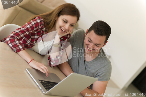 Image of happy young couple buying online