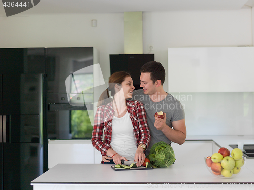 Image of Young handsome couple in the kitchen