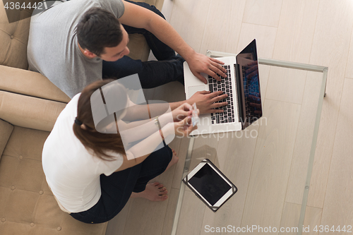 Image of happy young couple buying online