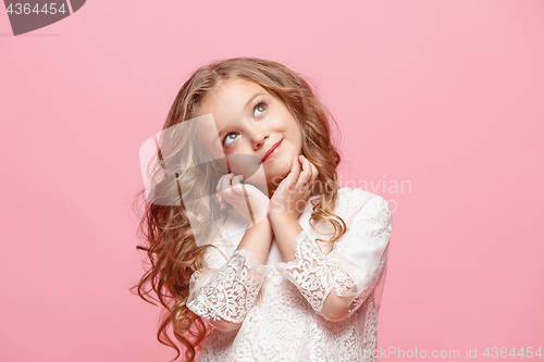 Image of The beautiful little girl in dress standing and posing over white background