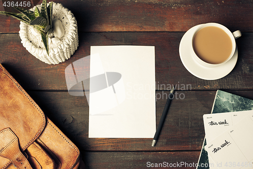 Image of Opened craft paper envelope , autumn leaves and coffee on wooden table