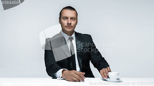 Image of The attractive man in black suit on white background