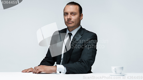 Image of The attractive man in black suit on white background