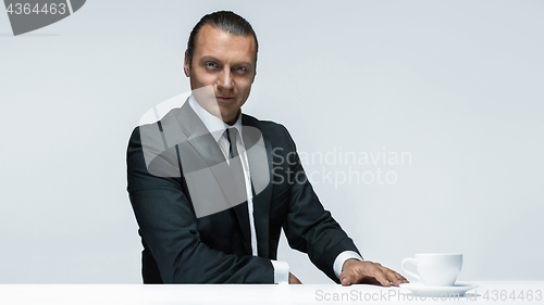 Image of The attractive man in black suit on white background