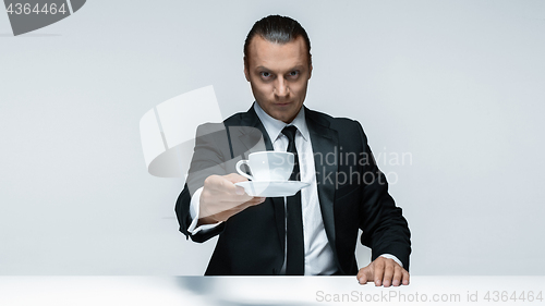 Image of The attractive man in black suit on white background