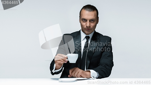 Image of The attractive man in black suit on white background