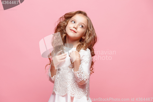 Image of The beautiful little girl in dress standing and posing over white background