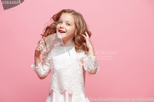 Image of The beautiful little girl in dress standing and posing over white background
