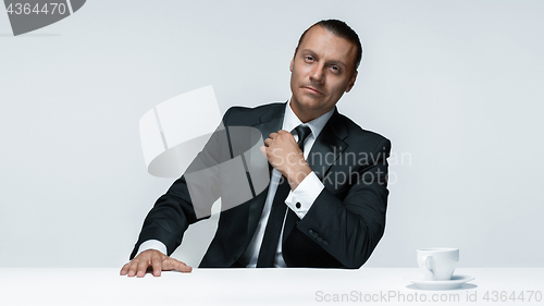 Image of The attractive man in black suit on white background