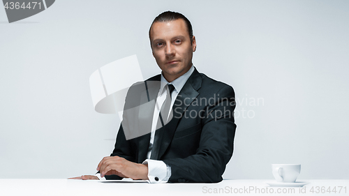 Image of The attractive man in black suit on white background