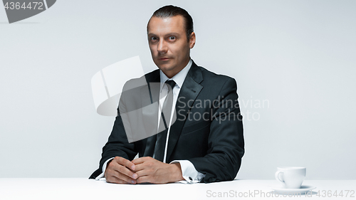 Image of The attractive man in black suit on white background