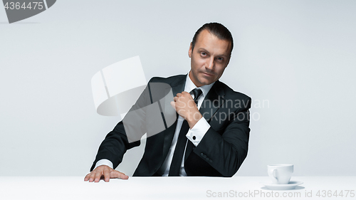 Image of The attractive man in black suit on white background