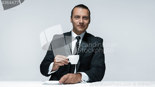 Image of The attractive man in black suit on white background