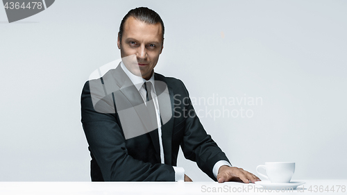 Image of The attractive man in black suit on white background