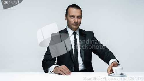 Image of The attractive man in black suit on white background