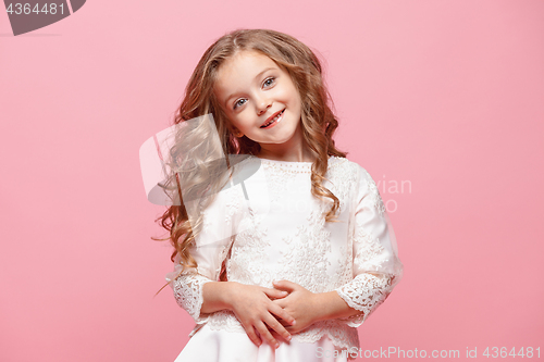 Image of The beautiful little girl in dress standing and posing over white background
