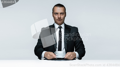 Image of The attractive man in black suit on white background