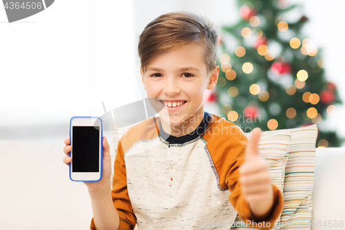 Image of boy with smartphone at christmas showing thumbs up