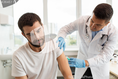 Image of patient and doctor with syringe doing injection