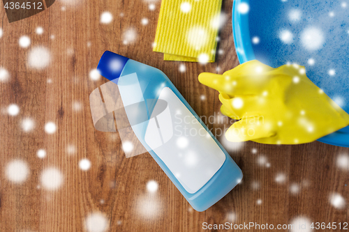 Image of basin with cleaning stuff on wooden background