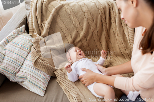 Image of mother soothing crying little baby boy at home