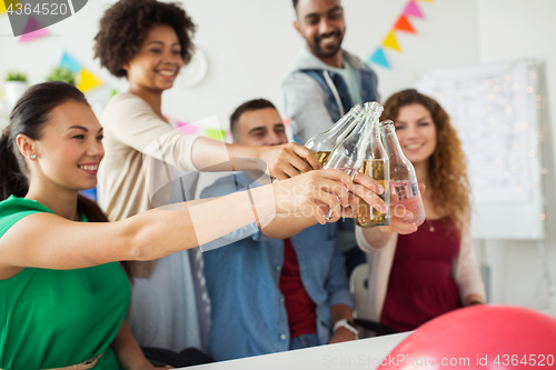 Image of happy team with drinks celebrating at office party