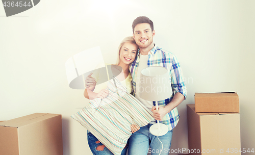 Image of happy couple with stuff moving to new home