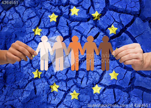 Image of hands holding chain of people over flag of europe