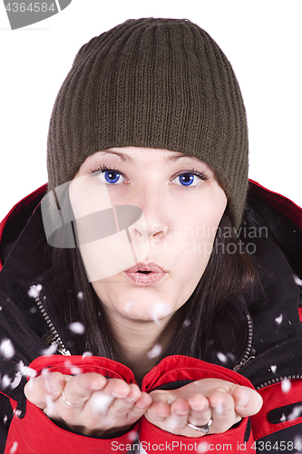 Image of Woman blowing soft white flakes