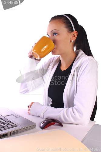 Image of  Teenager Drinking Coffee While Working on the Computer