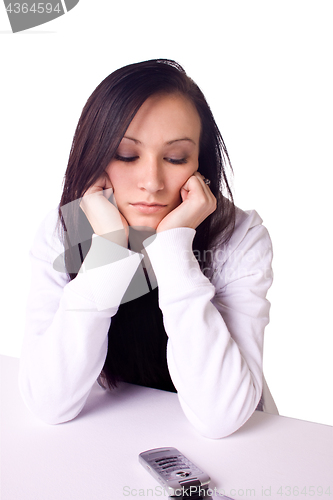 Image of Beautiful Teenager Looking at her Phone Waiting for a Phone Call