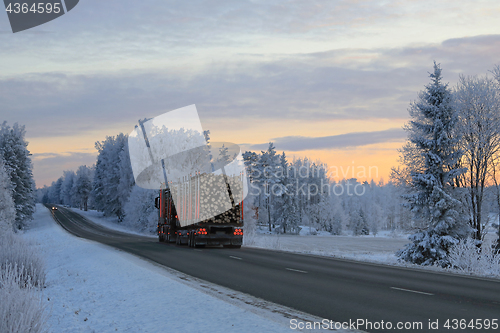 Image of Dusktime Winter Road with Logging Truck