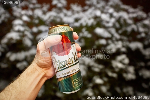 Image of Holding beer in snowy weather