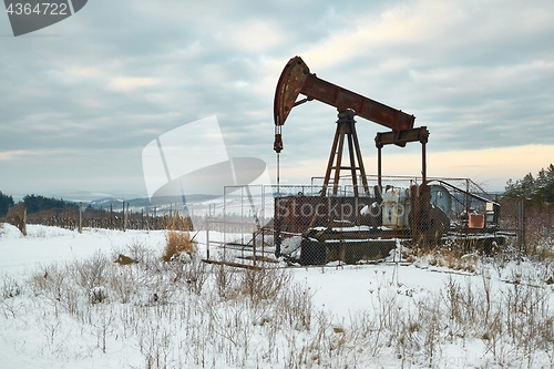 Image of Oil well on a winter landscape