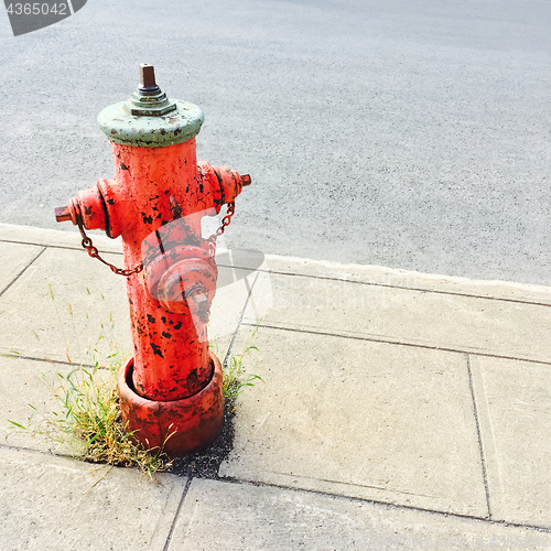 Image of Red fire hydrant on urban street