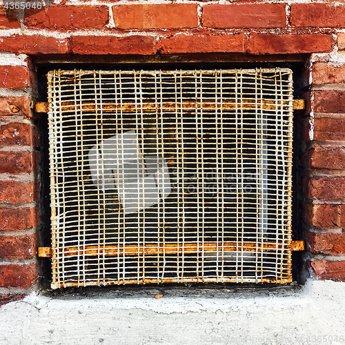 Image of Old wire mesh protecting a basement window