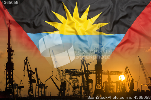 Image of Industrial concept with Antigua Barbuda flag at sunset