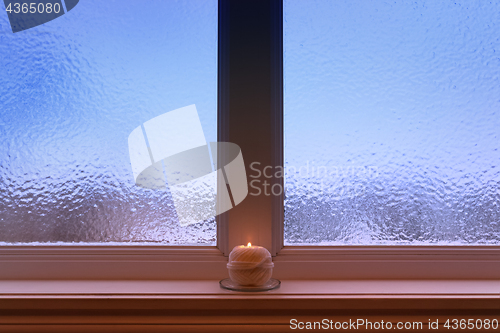 Image of Ball of yarn candle on a windowsill