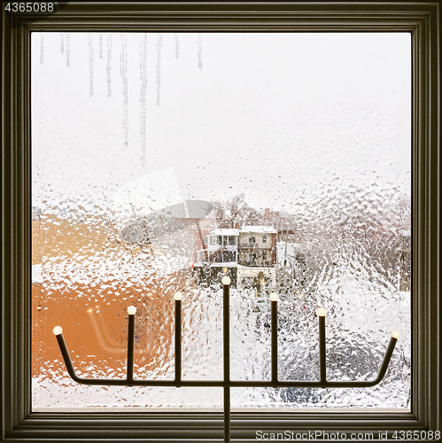 Image of Icicles on a frosted window decorated with LED lights