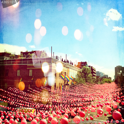 Image of Joyful summer street in gay neighborhood decorated with pink bal