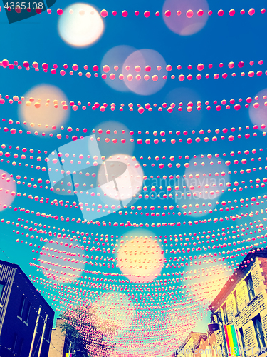 Image of Festive street in gay neighborhood decorated with pink balls