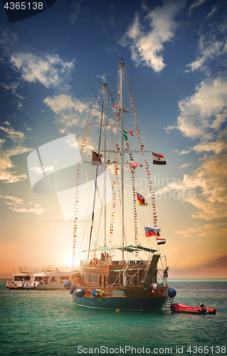 Image of Wooden sailboat at sunset