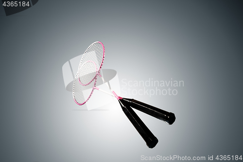 Image of Color photo of two rackets for badminton