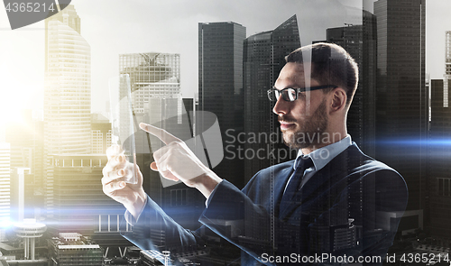 Image of businessman working with transparent tablet pc