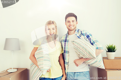 Image of happy couple with stuff moving to new home