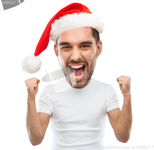 Image of screaming man in santa hat celebrating victory