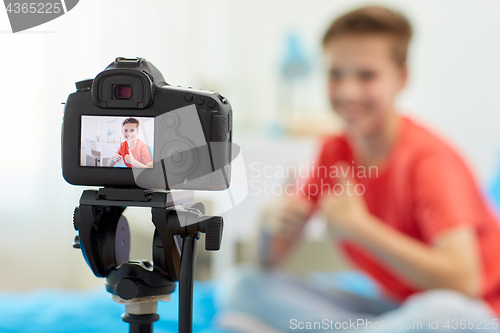 Image of camera recording video of blogger boy at home