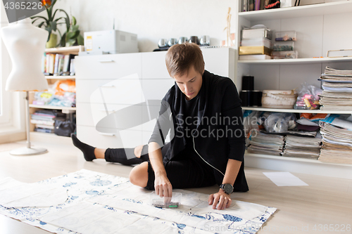 Image of fashion designer with cloth making dress at studio